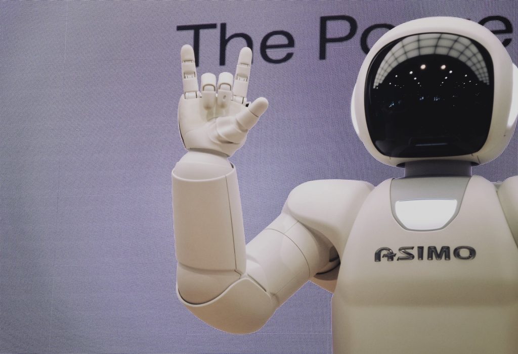 asimo robot posing with hand making a sign