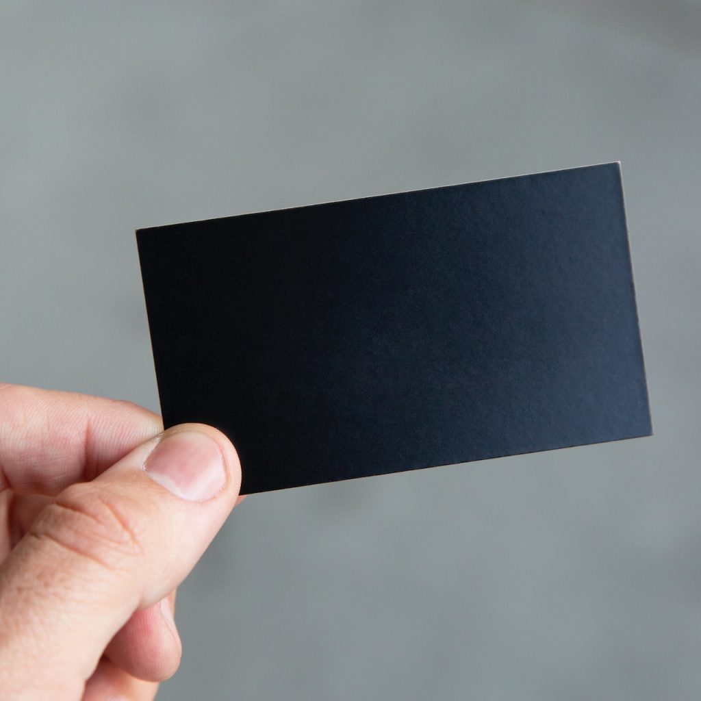 hand holding a black card